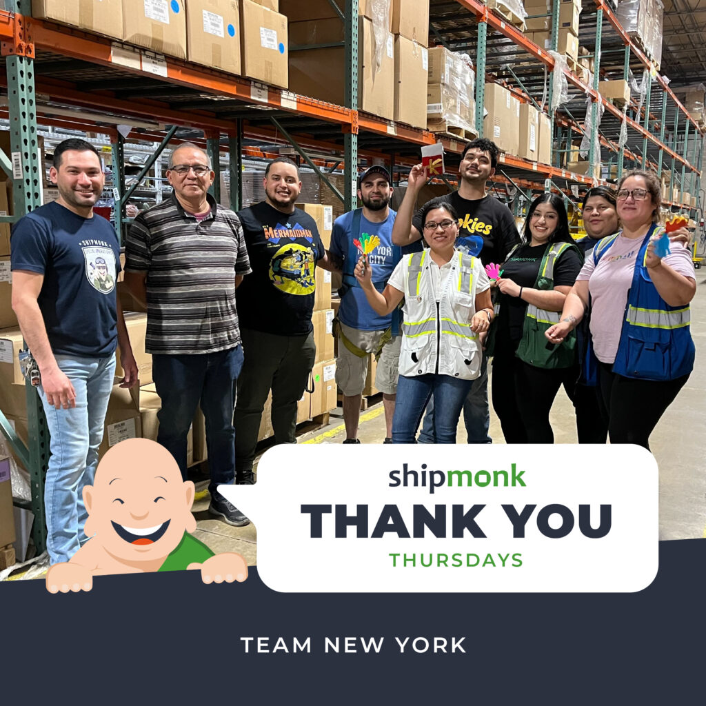 Imagine a snapshot capturing the essence of teamwork in its finest form. Here we have our spirited ShipMonk warehouse team, standing proudly before shelves positively bursting with boxes, showcasing the lifeblood of logistics! In their casual attire and trusty safety vests—because safety never takes a back seat—they hold small treasures with pride and dedication. The Thank You Thursdays Team New York banner elegantly draped below adds a touch of heartfelt gratitude to this vibrant tableau. It’s more than just logistics; it’s about family, camaraderie, and making sure you always feel like youre part of something bigger at ShipMonk.com. via ShipMonk.com