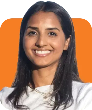 A cheerful woman in a white top beams against an orange backdrop, capturing ShipMonk.com’s bright, uplifting spirit. via ShipMonk.com